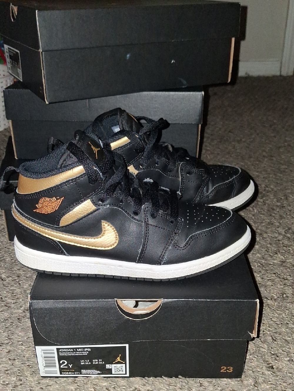 Jordan Black and Gold Mid-Top Sneakers
